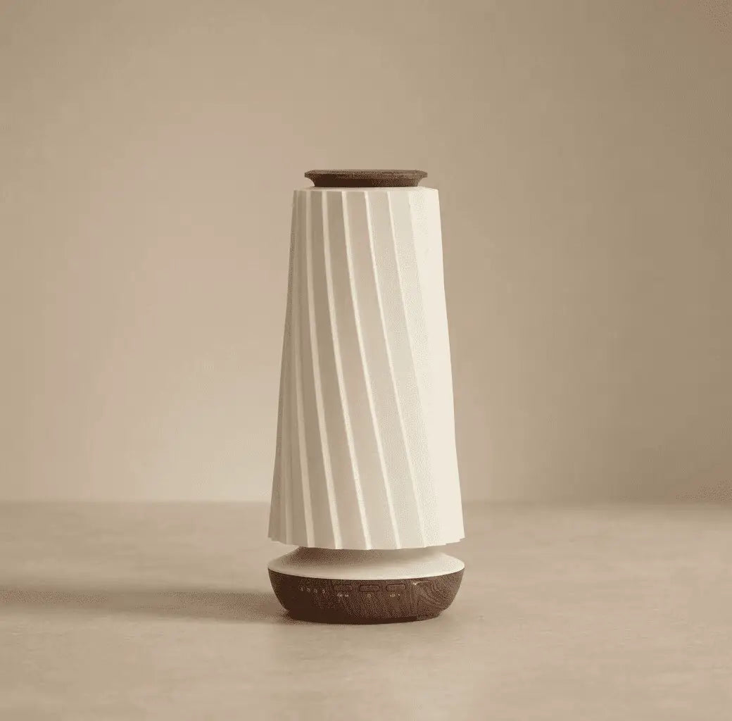 Decorative air diffuser displayed on a wooden table in a calm interior setting with natural light and neutral tones